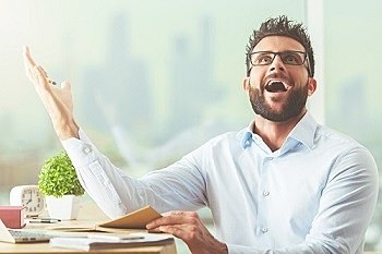 Handsome young businessman at workplace just understood a simple thing