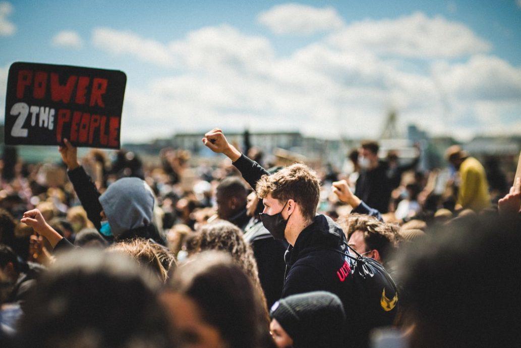 raised fist protester 1033x690.jpg
