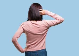 Young pretty woman showing back, posing and waiting, looking back