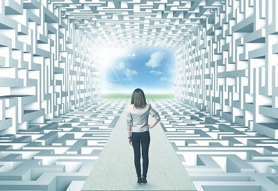 Successful businesswoman in front of a complicated labyrinth