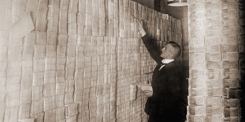 Piles of German money in a Berlin bank during the post World War I hyper inflation. In 1923 an American dollar was worth 800 million German marks.