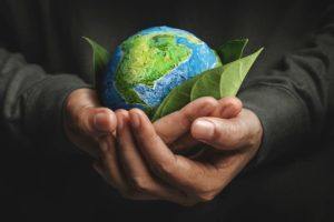 World Earth Day Concept. Green Energy, Renewable and Sustainable Resources. Environmental and Ecology Care. Hand Embracing Green Leaf and Handmade Globe