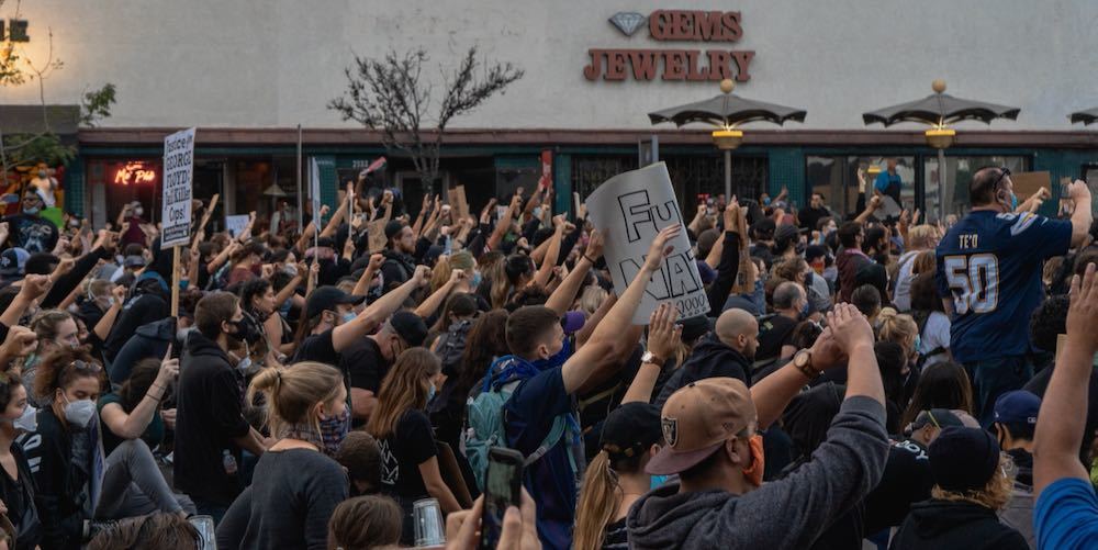 San Diego, CA / USA   6/4/20: Protesters raise a fist as they march through the streets of North Park in wake of the George Floyd killing by police