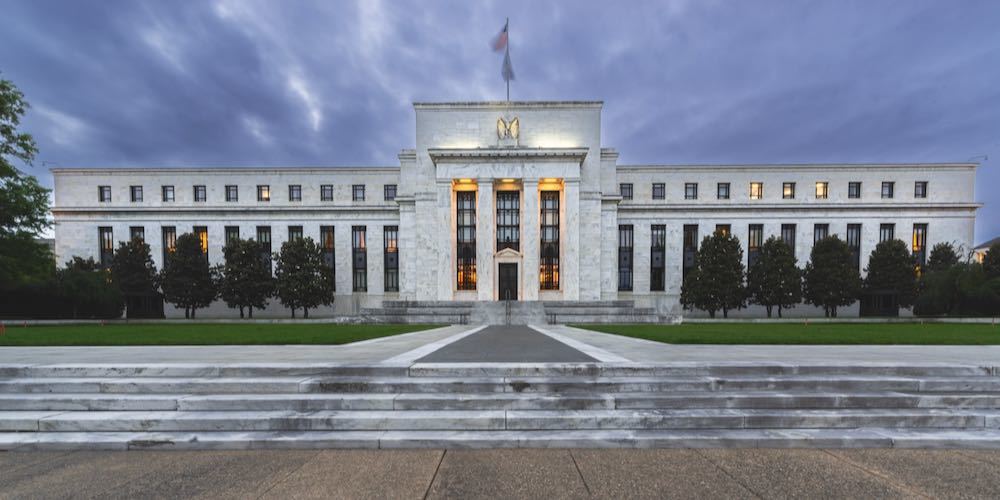 Washington DCâ€”May 15, 2021; view of the the front of the United States Federal Reserve illuminated at Dusk in Spring with cloudy sky