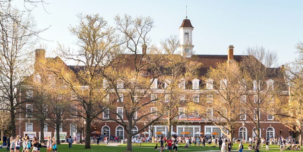 URBANA, ILLINOIS   APRIL 17, 2016:  Students walk and sit outside on Quad lawn of University of Illinois college campus in Urbana Champaign