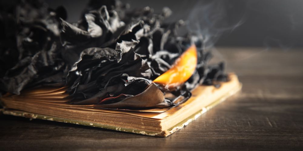 Burning book on the wooden table.
