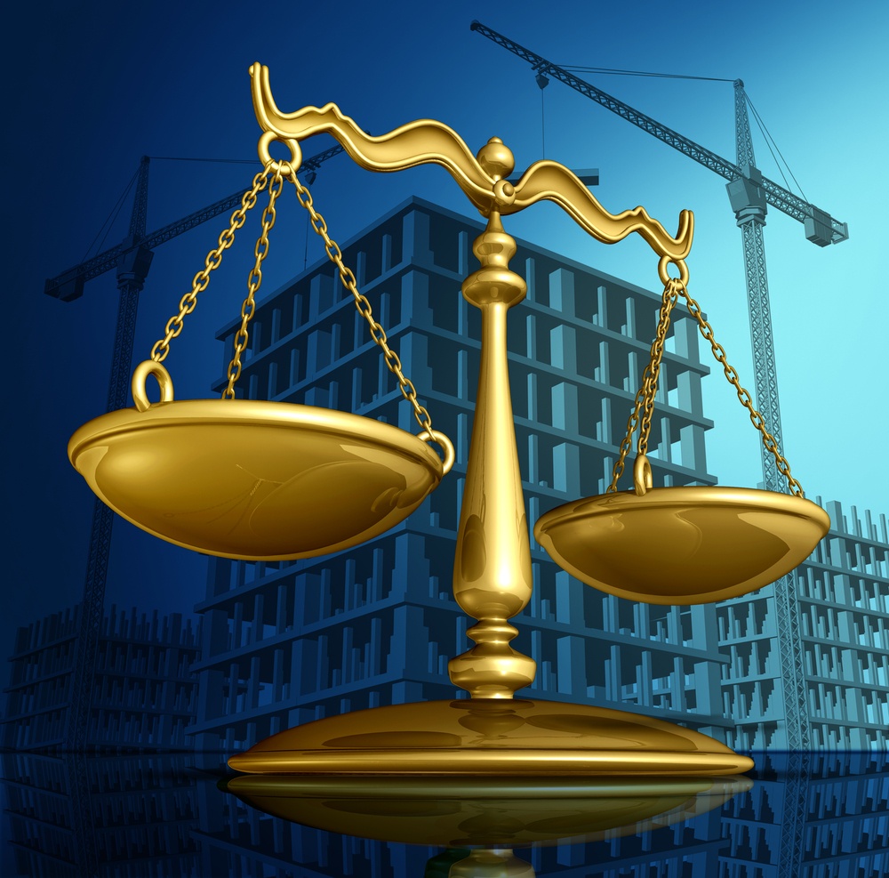 Construction law concept as a justice scale over a working building site with cranes and a structure being built as a concept for architecture permits and real estate regulations.