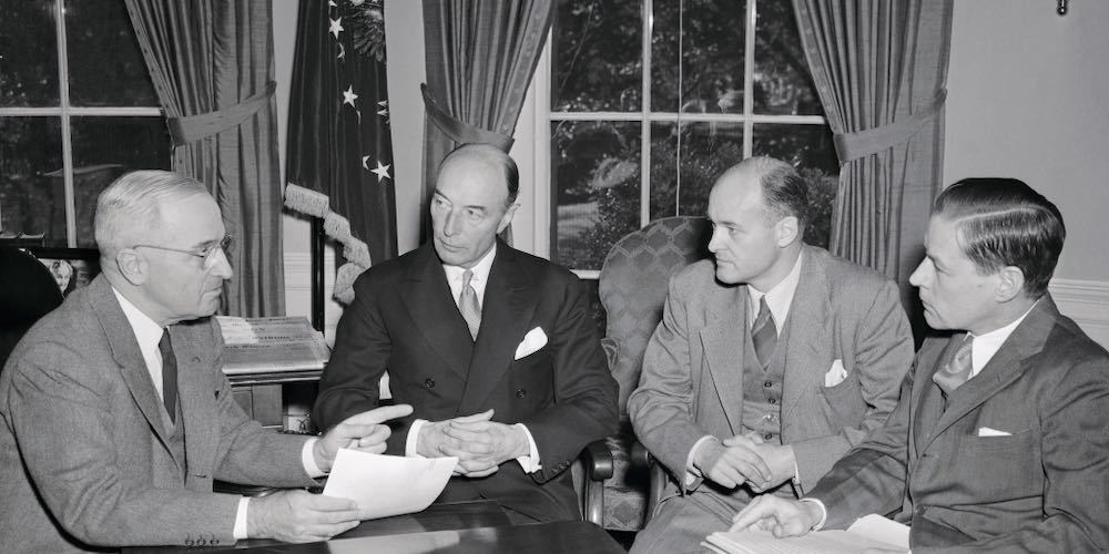 (Original Caption) President Truman today received a progress report on preparations for the forthcoming meeting of the Council of Foreign Ministers in London. Shown at the meeting at the White House are (l r): President Truman; Undersecretary of State Robert Lovett; George F. Kennan, Director of the Policy Planning Staff of the State Department; Charles E. Bohlen, special assistant to Secretary Marshall.