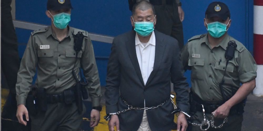 Owner of Apple Daily Newspaper Jimmy Lai is seen shackled as prison guards escort him to a prison van at Lai Chi Kok Reception Center on December 12, 2020 in Hong Kong, China. Jimmy Lai is set to appear before a court in Hong Kong today on Charges under the newly implemented National Security Law. (Photo by Vernon Yuen/NurPhoto)