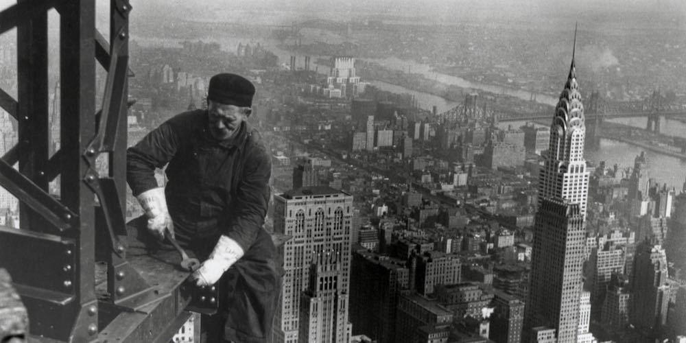 Middle aged iron worker at the Empire State Building construction site, 1930. The Chrysler Building's spire is at right. Photo By Lewis Hine.