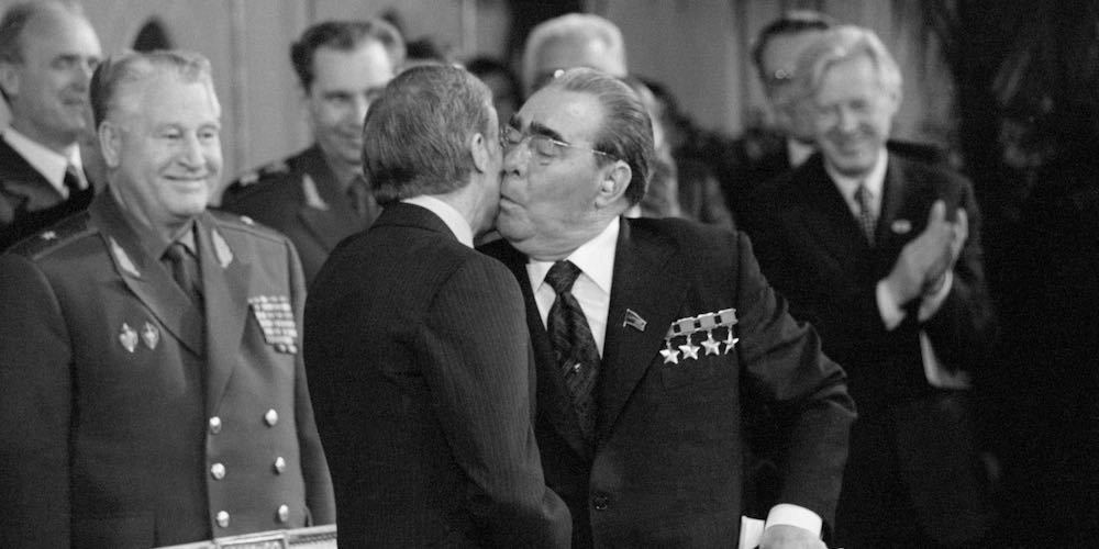 (Original Caption) 6/17/1979 Vienna, Austria  Soviet President Brezhnev, holding the signed copy of the SALT II Treaty, plants a kiss on the cheek of President Jimmy Carter. The treaty was signed at the Redoutensaal after two days of meetings.