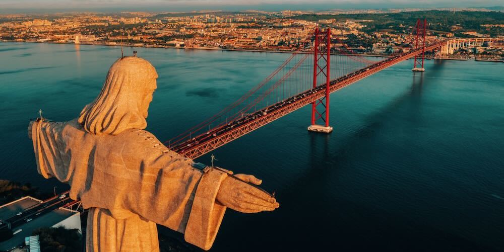 Aerial view of Sanctuary of Christ the King, Santuario de Cristo Rei. Lisbon, Portugal. Drone photo at sunrise. Catholic monument
