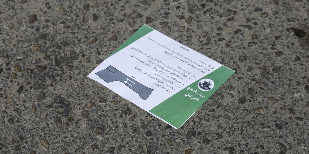 13 October 2023, Palestinian Territories, Gaza City: A leaflet lies on the ground dropped by Israeli army planes above Gaza City, asking them to flee to the south of the Strip immediately. Israel's military on Friday ordered the evacuation of 1 million civilians from northern Gaza amid preparations for a threatened ground offensive aimed at crushing the Hamas militant group that rules the Palestinian territory. Photo by: Mohammed Talatene/picture alliance/dpa/AP Images
