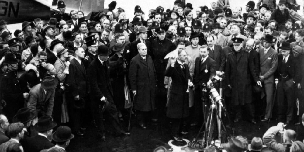 Neville Chamberlain waving his Munich agreement at the airport on his return to England, 1938.