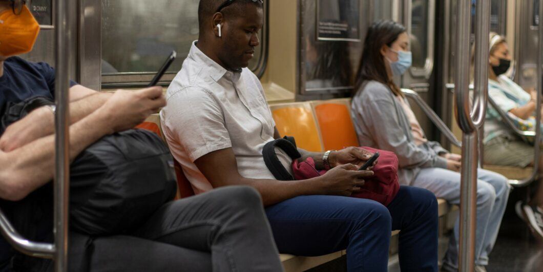 People on their phones on subway shutterstock 2259222103 1060x531.jpg