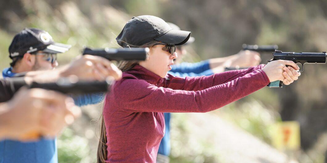 Young people on tactical gun training classes. Shooting and Weapons. Outdoor Shooting Range