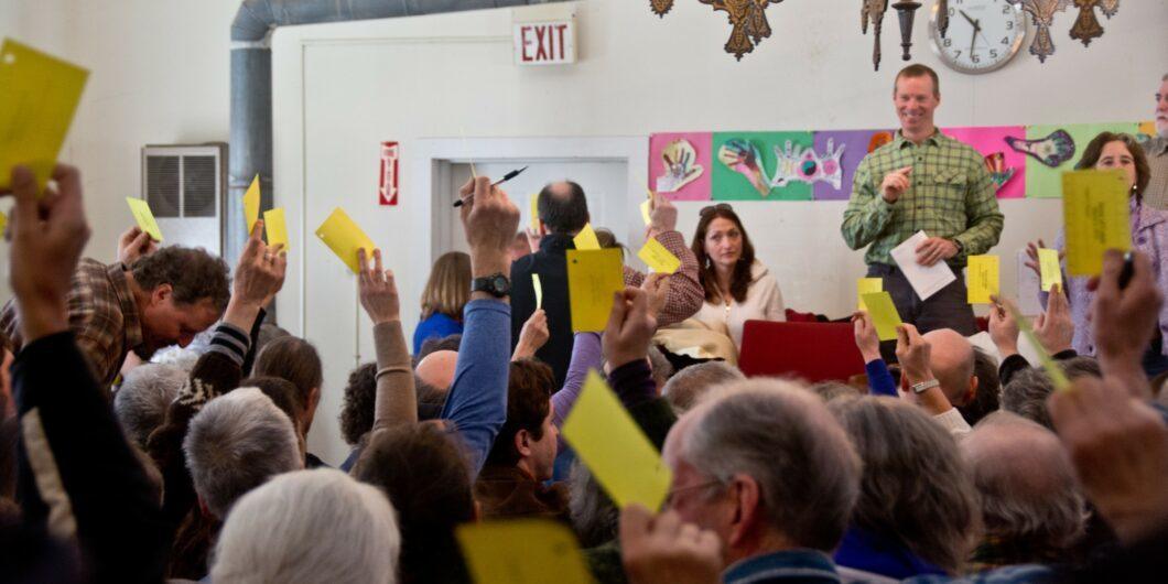 voters at school board mtg shutterstock 179909720 1060x530.jpg
