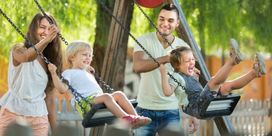 parents w kids on swings shutterstock 282010403 1060x531.jpg