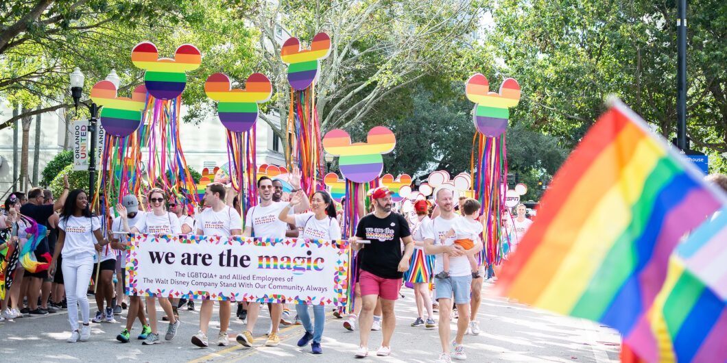 Orlando, Florida, USA. October 15, 2022. Group of members of the LGBTIQIA+ community Employees of The Walt Disney Company in Come Out With Pride Orlando parade on the E Central Blvd street.
