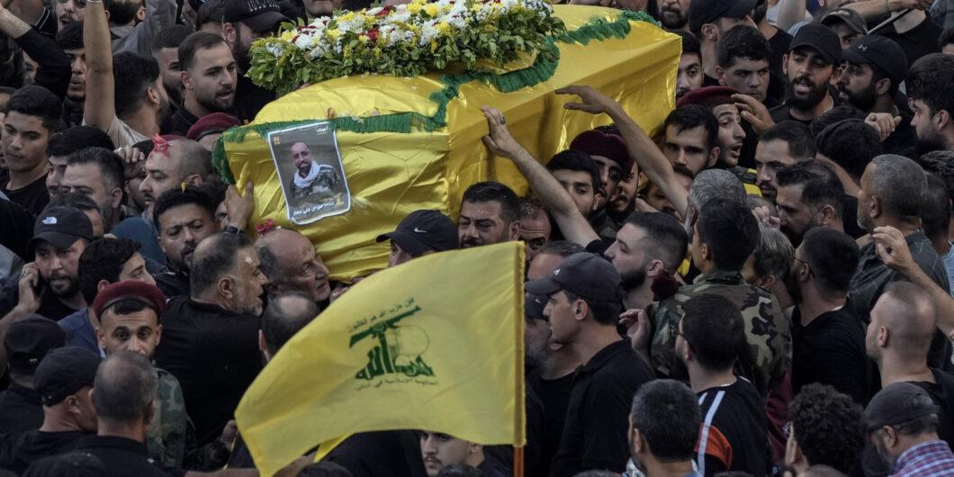 Mourners carry the coffin of Mohammed Mahdi, son of Hezbollah legislator Ali Ammar, who was killed Tuesday after his handheld pager exploded, in the southern suburb of Beirut, Lebanon, Wednesday, Sept. 18, 2024. (AP Photo/Bilal Hussein)