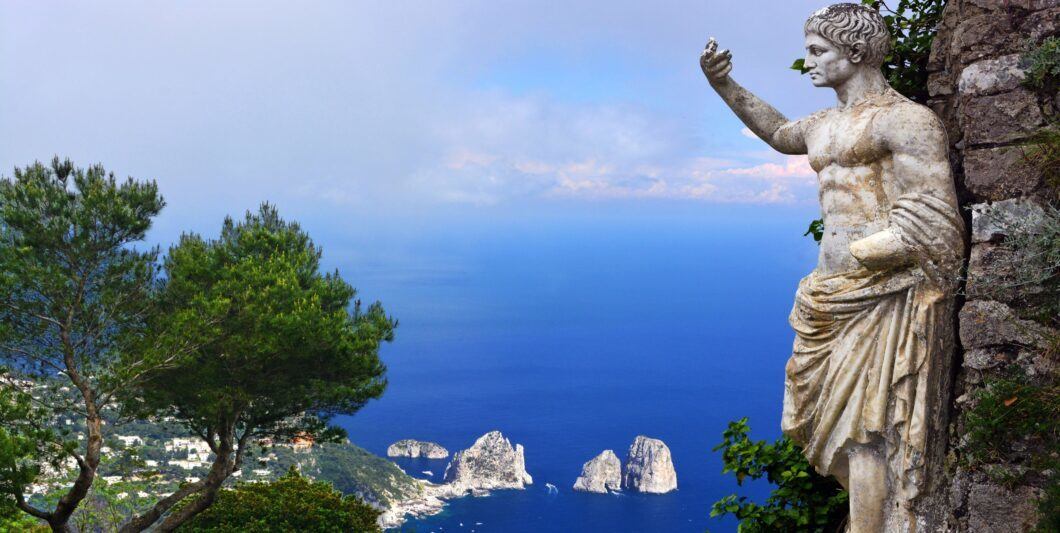 Statue of Augustus  Faraglioni rocks Capri 1060x533.jpg