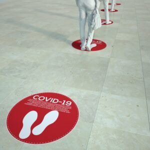 3D rendering of people standing in a queue with social distancing floor markers