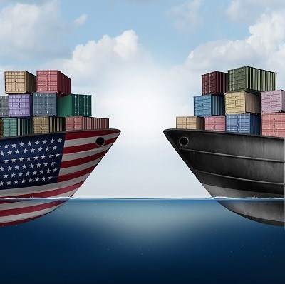 American trade war tariffs in the United states as two opposing cargo ships as an economic  taxation dispute over import and exports concept as a 3D illustration.