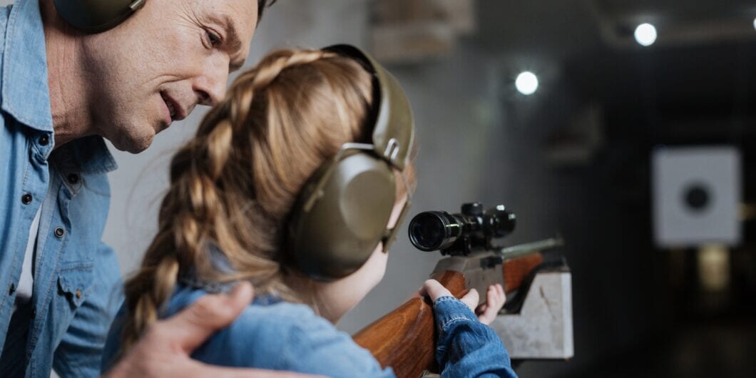 Pleasant cheerful man helping his daughter