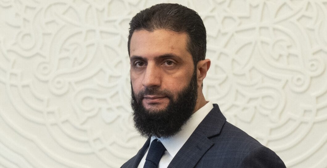 Syria's de facto leader Ahmad al Sharaa, formerly known as Abu Mohammed al Golani, walks in the presidential palace ahead of his meeting with Walid Ellafi, Libyan minister of state for communication and political affairs, in Damascus, Saturday, Dec. 28, 2024. (AP Photo/Mosa'ab Elshamy)