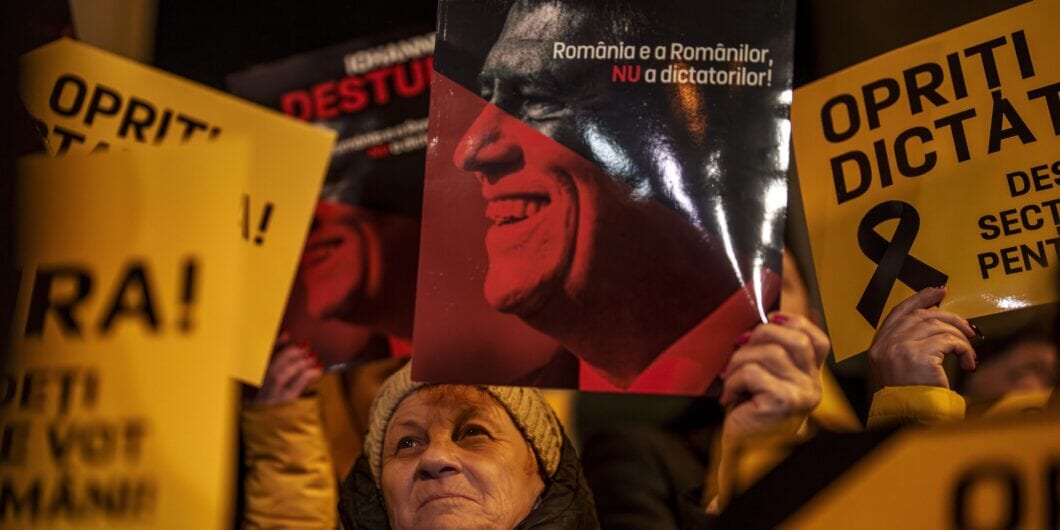 Supporters of the right wing Alliance for Unity of the Romanians (AUR) hold banners that read 