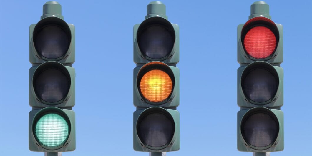 Traffic light sequence: green, yellow and red light. Isolated in the sky.