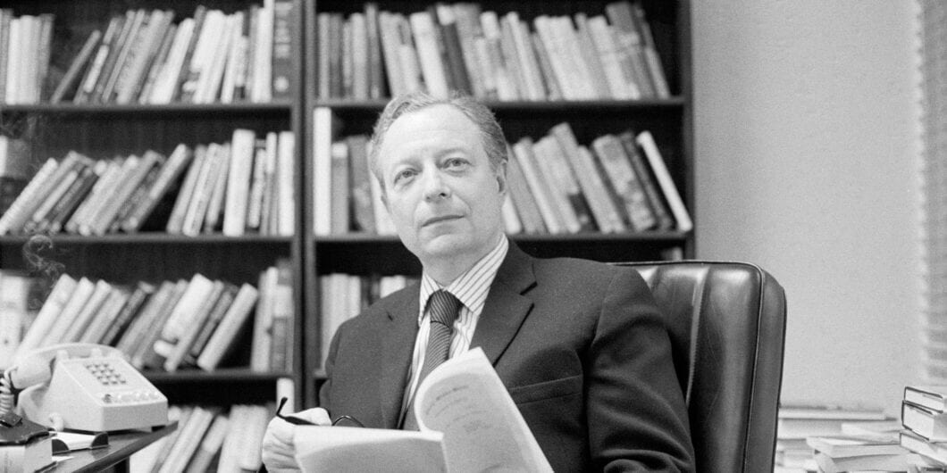 Magazine editor and writer Irving Kristol, a Neo Marxist turned Neo Conservative, sits at his desk surrounded by books.