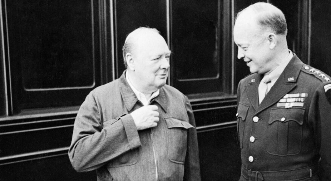 Winston Churchill shows off his famous siren suit to General Dwight D Eisenhower during a tour of Allied invasion forces in Kent 12 May 1944. H38458 e1746541624617 1060x580.jpg