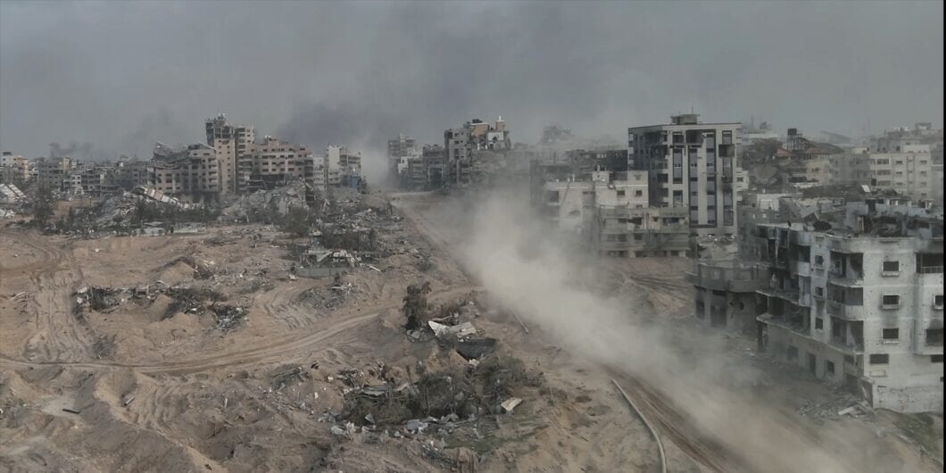 Tank driving with dust in al shati refugee camp, Gaza, aerial