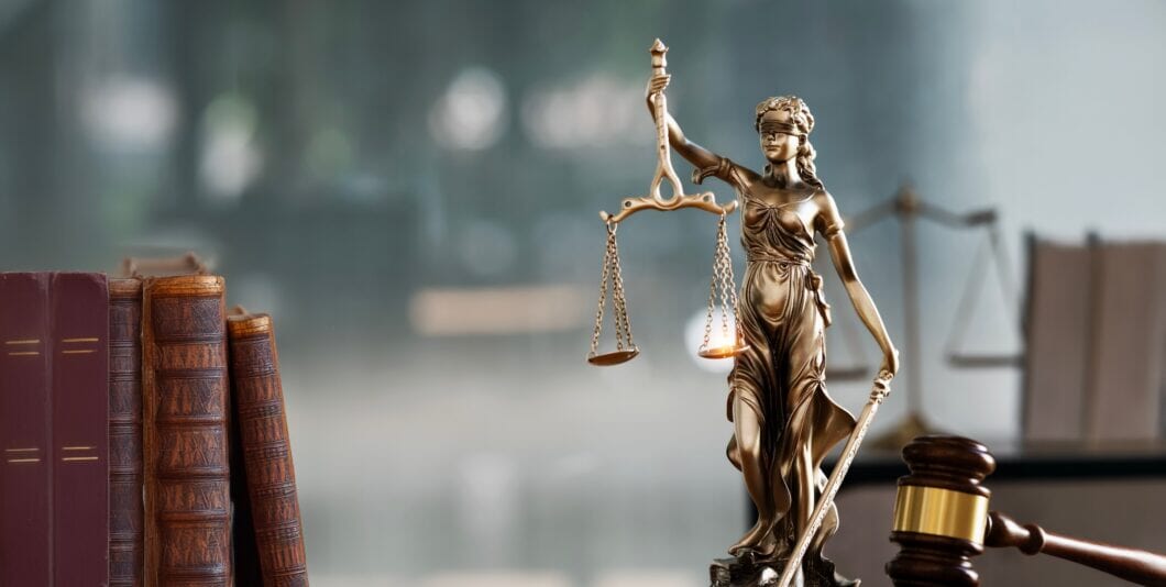Legal and law concept. Statue of Lady Justice with scales of justice and wooden judge gavel on wooden table. Panoramic image statue of lady justice.