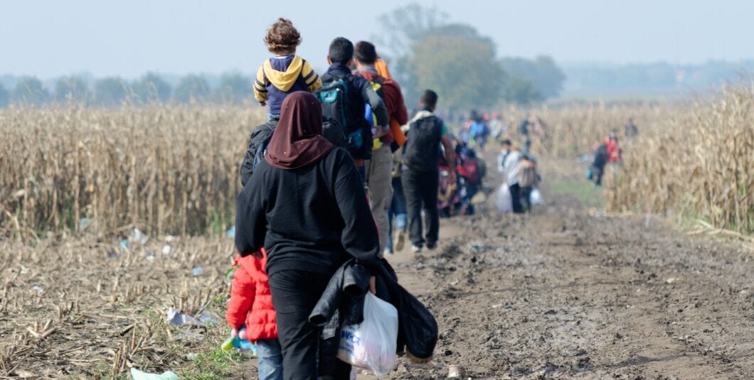 2015.10.18 Sid, Croatia and Serbia border: Refugees walking through the cornfield. Migrants trying to cross the Croatian border to enter the European Union in search for a better life.