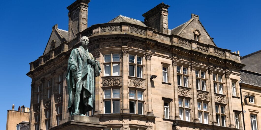 Edinburgh, Scotland, UK   June 7, 2018: Bronze statue of William Pitt the Younger a British Prime Minister on George and Frederick streets Edinburgh Scotland with historic buildings