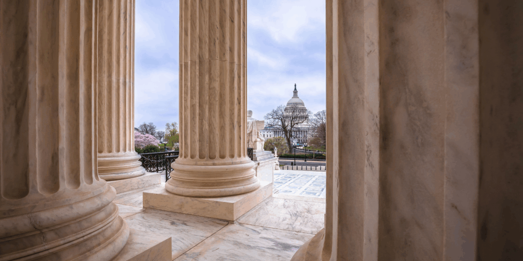 US Supreme Court pillars looking at Capitol Bldg 1060x530.png