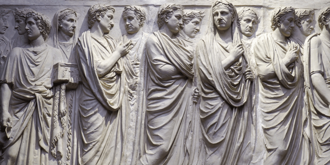 wall sculpture of Roman men in gowns 1060x530.png